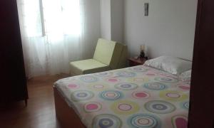 a bedroom with a bed and a chair at Apartments by the sea Zaglav, Dugi otok - 12424 in Zaglav