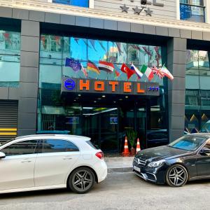 dos coches blancos estacionados frente a un hotel en Grand Nergiz Otel, en Antalya