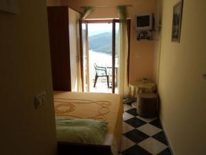 a room with two beds and a balcony with a table at Apartments and rooms with parking space Rabac, Labin - 12368 in Rabac