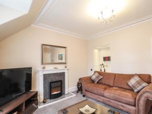 a living room with a couch and a fireplace at Firthview in Buckie