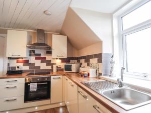 a kitchen with a sink and a window at Firthview in Buckie