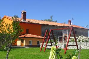 a house with a playground in front of a yard at Family friendly house with a parking space Presika, Labin - 12472 in Labin