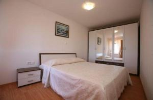 a bedroom with a bed and a large mirror at Family friendly house with a parking space Presika, Labin - 12472 in Labin