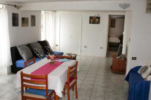 a living room with a table and a couch at Apartments by the sea Sibenik - 12454 in Šibenik