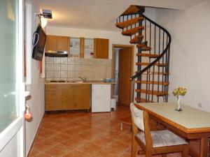 a kitchen and dining room with a spiral staircase at Holiday house with a parking space Borje, Peljesac - 12506 in Orebić