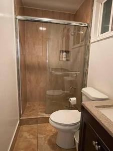 a bathroom with a toilet and a glass shower at Cozy 2b/2b residential home in Berkeley in Berkeley