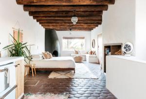 a living room with a bed and a fireplace at The JTH Tucson in Tucson