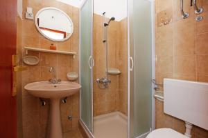 a bathroom with a shower and a sink and a toilet at Apartments by the sea Prizba, Korcula - 12648 in Prizba