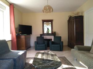 a living room with a couch and chairs and a table at Lorraine country house near Lake Madine, Lahayville in Lahayville