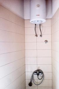 a white tiled shower with a light in a bathroom at Apartments by the sea Cove Salbunara - Bisevo, Vis - 12700 in Komiža