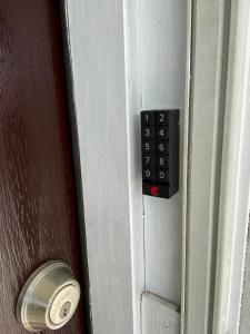 a close up of a door with a unlock button at Cozy 3-bed home close to beautiful beaches. in New Port Richey