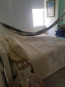 a bedroom with a bed with a hammock above it at Ipanema RJ 2 quartos in Rio de Janeiro