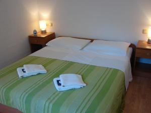 a bedroom with two beds with towels on them at Apartment Pag 12795a in Pag