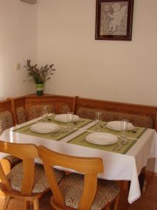 a dining room table with plates and glasses on it at Apartment Pag 12795a in Pag