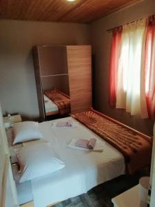 a bedroom with two beds and a large mirror at Secluded holiday house Cove Nevidjansko Polje, Pasman - 12806 in Neviđane
