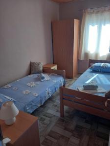 a small bedroom with two beds and a table at Secluded holiday house Cove Nevidjansko Polje, Pasman - 12806 in Neviđane