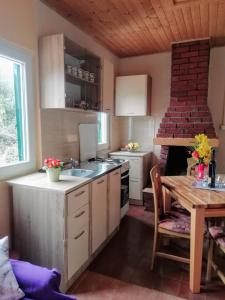 a kitchen with a table and a stove top oven at Secluded holiday house Cove Nevidjansko Polje, Pasman - 12806 in Neviđane