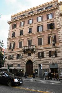 a large brick building on the corner of a street at Hotel Martini in Rome