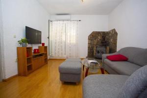 a living room with a couch and a fireplace at Apartments with parking space Podgora, Makarska - 12816 in Podgora
