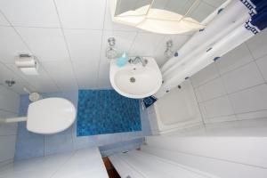 a white bathroom with a sink and a shower at Apartments with parking space Podgora, Makarska - 12816 in Podgora +20 photos