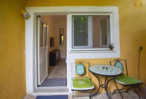 a table and two chairs sitting next to a door at Apartments with parking space Podgora, Makarska - 12816 in Podgora