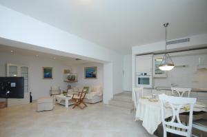 a living room and dining room with a table and chairs at Family friendly house with a swimming pool Mlini, Dubrovnik - 12828 in Mlini