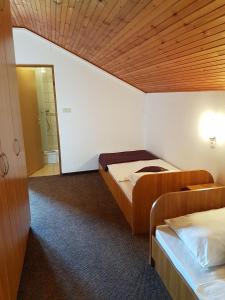 a room with two beds and a hallway with a mirror at Rooms with a parking space Grabovac, Plitvice - 12835 in Rakovica