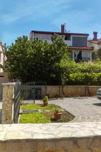 a garden in front of a house at Apartments with WiFi Fazana - 12862 in Marana