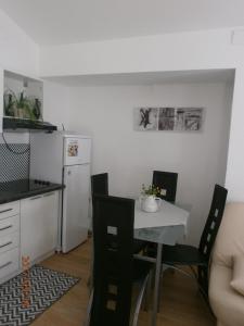 a kitchen with a table and chairs and a refrigerator at Apartments with a parking space Samobor, Prigorje - 12869 in Samobor