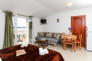 a room with a bed and a couch and a table at Studio Lopud 12910b in Lopud
