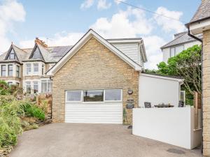 a brick house with a white garage at The Beach House in Crantock