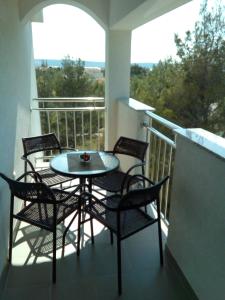 a table and chairs on a balcony with a view at Apartments with a parking space Starigrad, Paklenica - 12992 in Starigrad