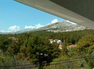 a view of a mountain with trees and buildings at Apartments with a parking space Starigrad, Paklenica - 12992 in Starigrad