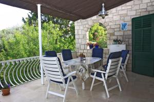 a table and chairs sitting on a patio at Seaside holiday house Postira, Brac - 13001 in Postira