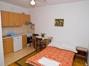 a kitchen with a bed and a table in a room at Apartments by the sea Brist, Makarska - 12991 in Podaca