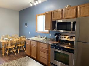 a kitchen with a sink and a stove top oven at Pelican Motel in Pelican Rapids +49 photos
