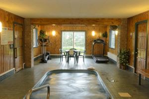 a room with a hot tub and a table at North Star Hotel Pictured Rocks in Munising