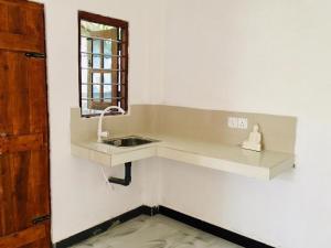 a bathroom with a sink and a mirror at Sujeewa Holiday Resort Anuradhapura in Anuradhapura