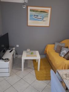 ein Wohnzimmer mit einem Sofa und einem Tisch in der Unterkunft Apartments by the sea Novalja, Pag - 13033 in Novalja