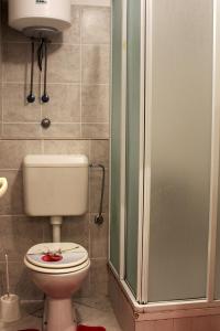 a bathroom with a toilet and a shower at Apartments by the sea Novalja, Pag - 13033 in Novalja