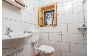 a bathroom with a toilet and a sink and a window at Secluded house with a parking space Trpanj, Peljesac - 13059 in Trpanj