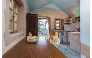 a kitchen with a table with a bowl of fruit on it at Secluded house with a parking space Trpanj, Peljesac - 13059 in Trpanj