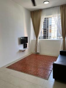 a living room with a couch and a large rug at OrchidVilla Homestay at Southville Apartment in Kampong Parit