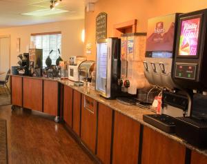 a bar in a restaurant with a counter top with coffee machines at North Star Hotel Pictured Rocks in Munising
