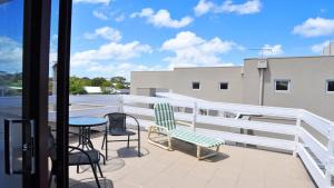 a balcony with a table and chairs on a building at Getaway On Garden Free Wifi Pet Friendly Outside Only in Inverloch