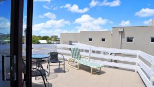 a balcony with a table and chairs on a building at Getaway on Garden in Inverloch