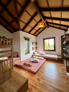 a large room with bunk beds and a wooden floor at Yen Bai Garden Ba Vi - Venuestay in Hanoi