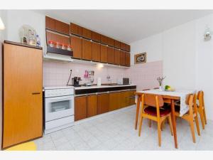 a kitchen with a table and a stove top oven at Apartments by the sea Hvar - 13109 in Hvar