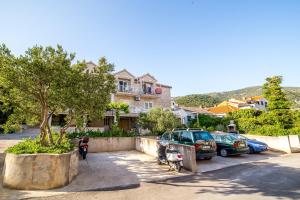 a group of cars parked in a parking lot at Apartments with parking space Bol, Brac - 12980 in Bol
