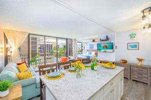 a kitchen and living room with a couch and a table at Remodeled 1BR Condo, Steps to Beach, Free Parking! in Honolulu